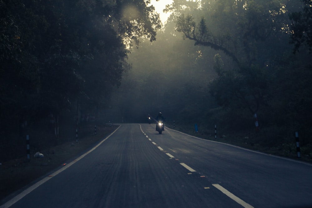 a motorcycle driving down a road