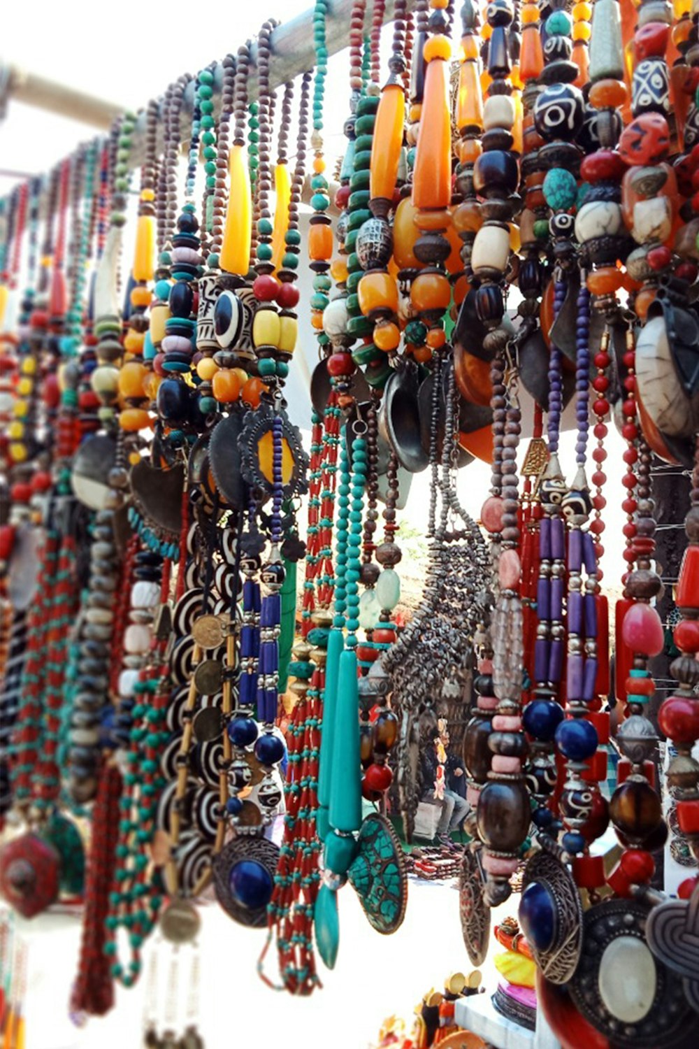 a large group of colorful necklaces