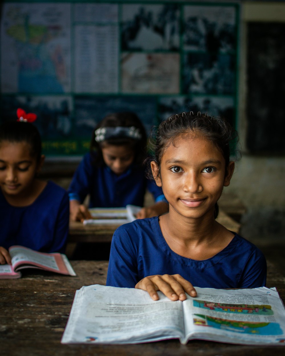 a few young girls in a classroom