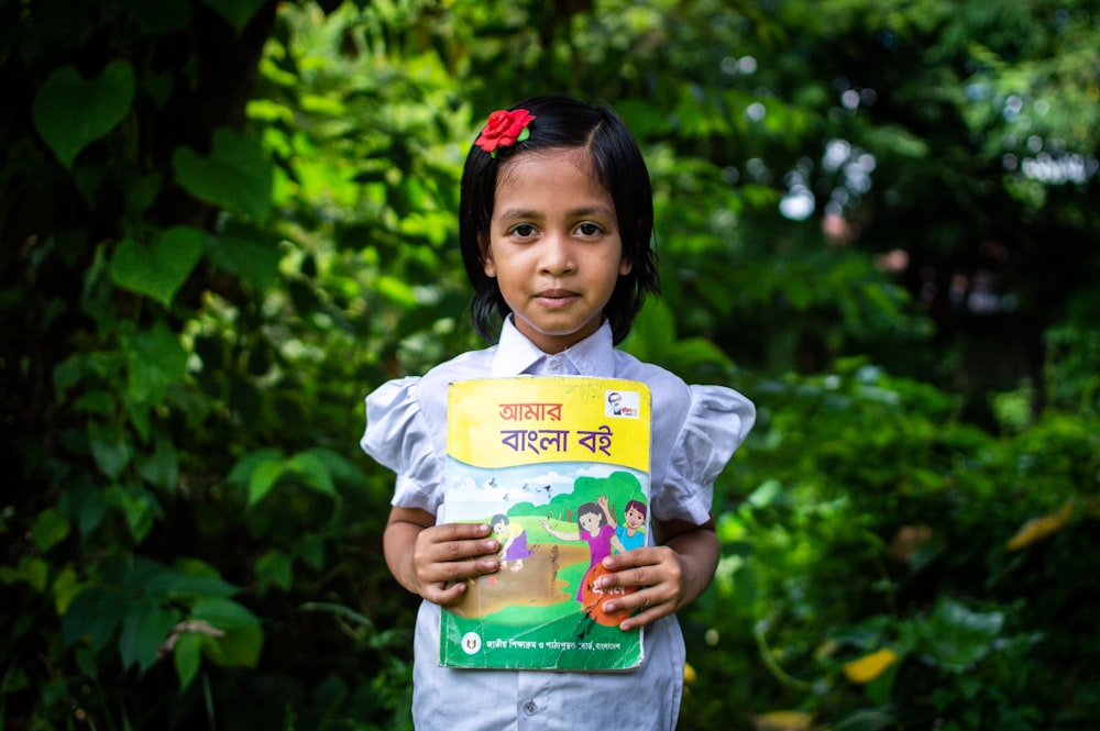 a girl holding a book