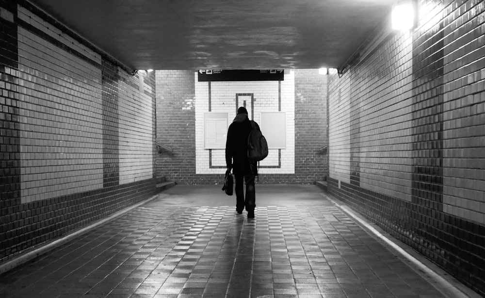 a man and woman walking in a tunnel