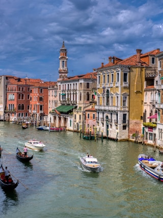 a canal with boats in it and buildings around it with Grand Canal in the background