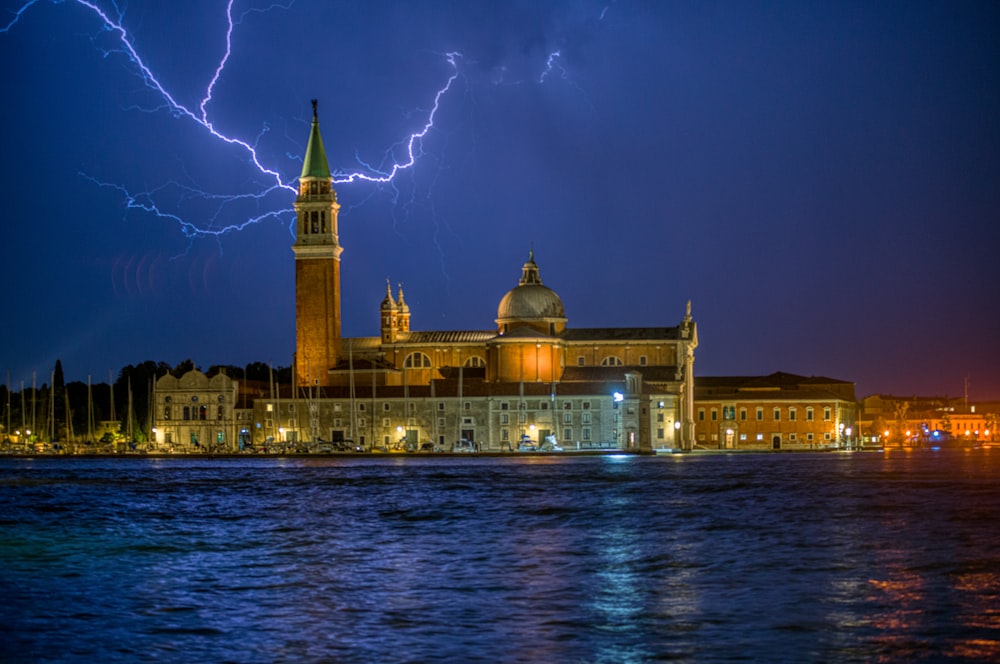 a building with a tower and a dome with lightning striking the top