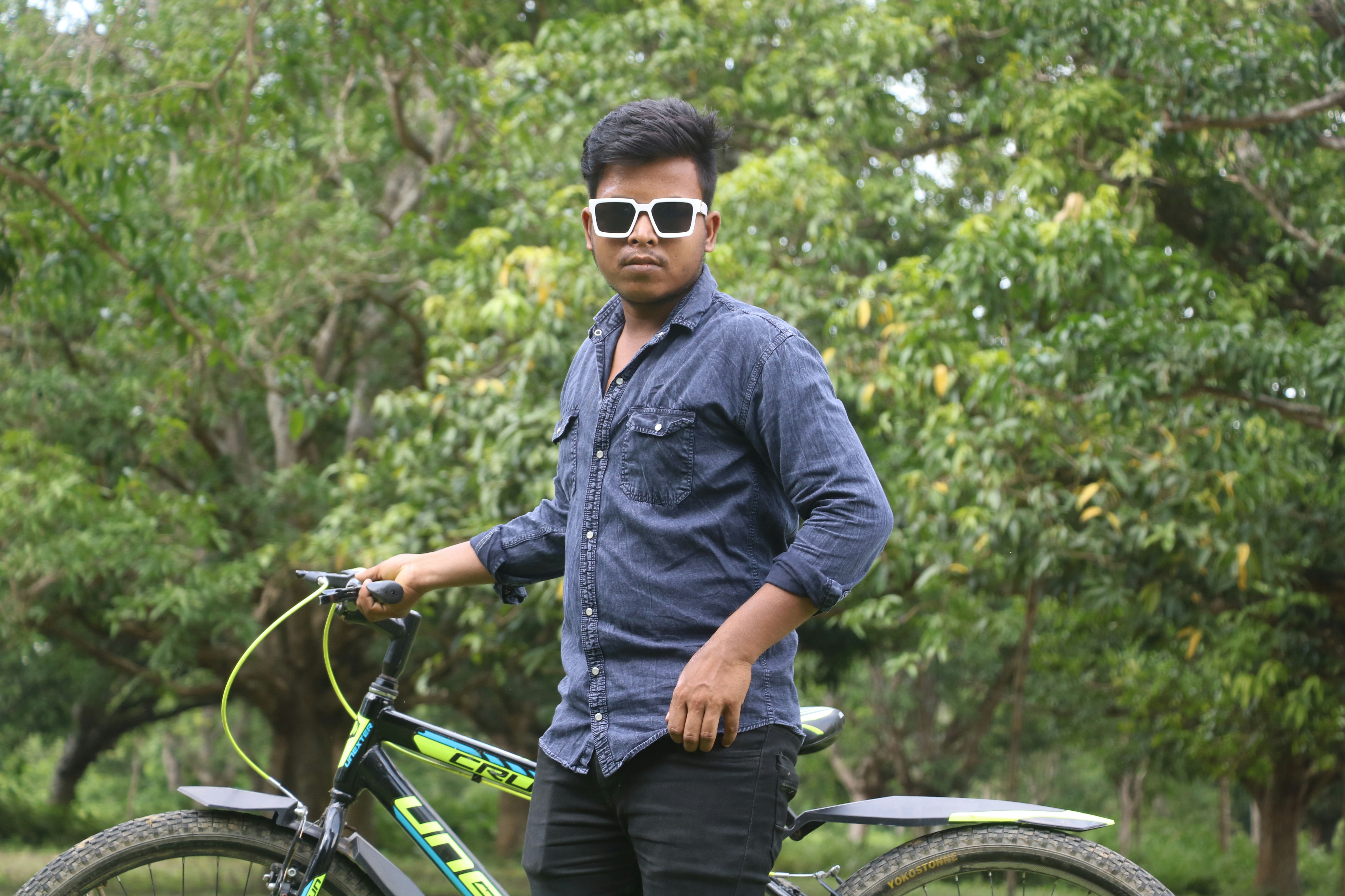 a man standing next to a bicycle