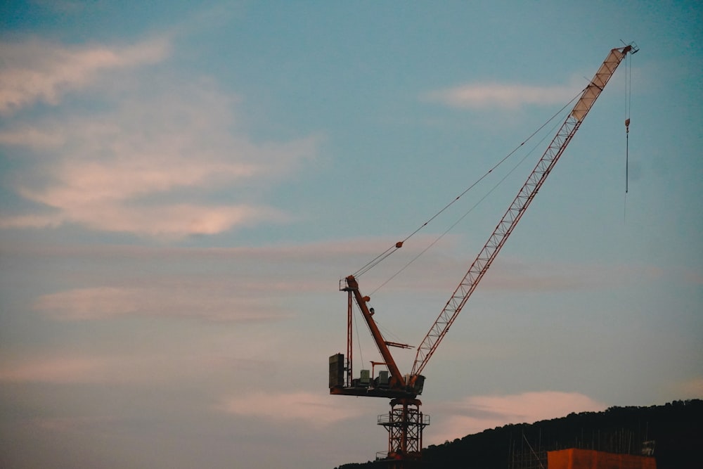 a large crane at sunset