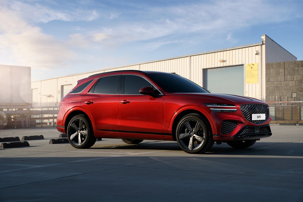 a red car parked in front of a building