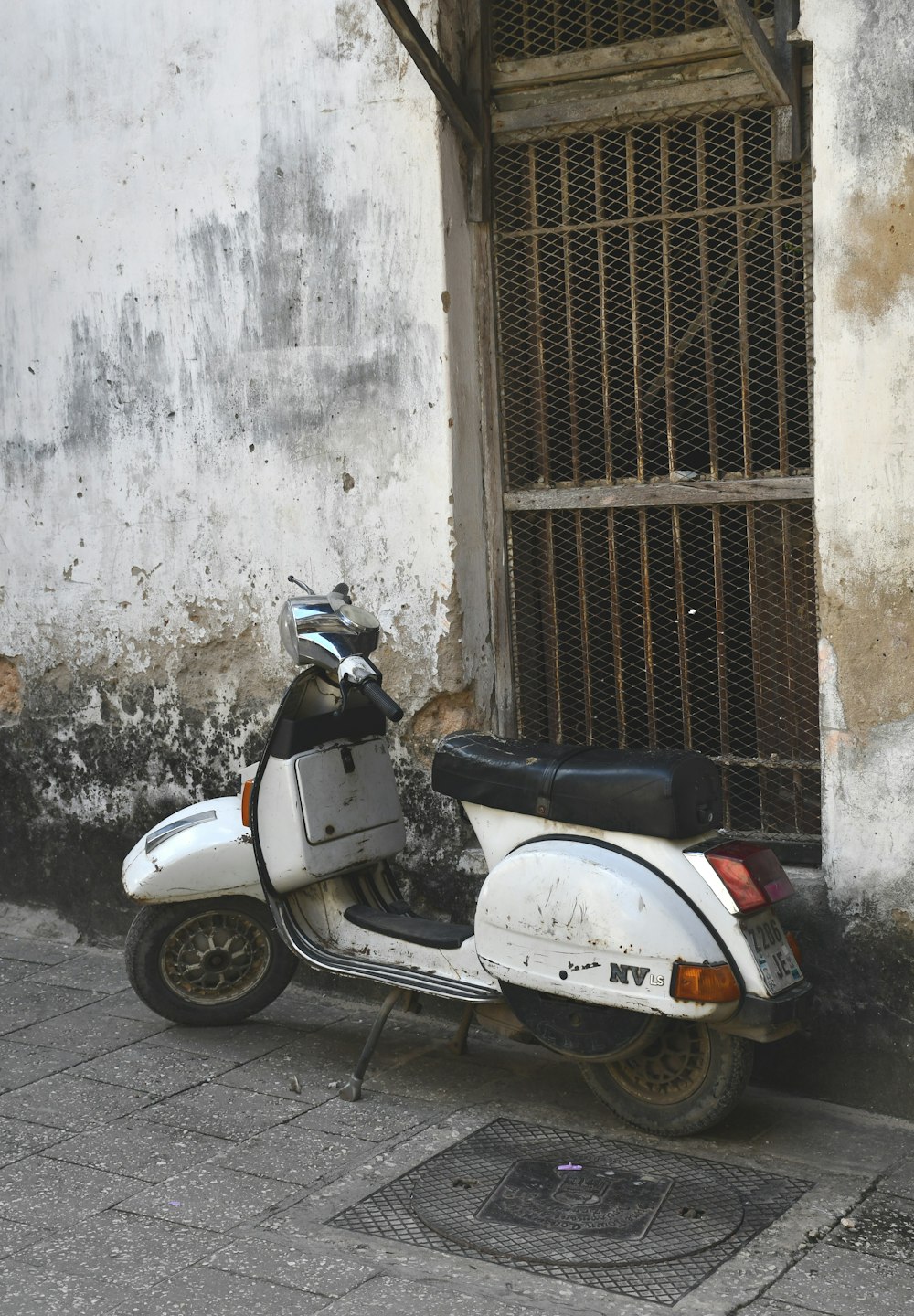 a moped parked outside a building