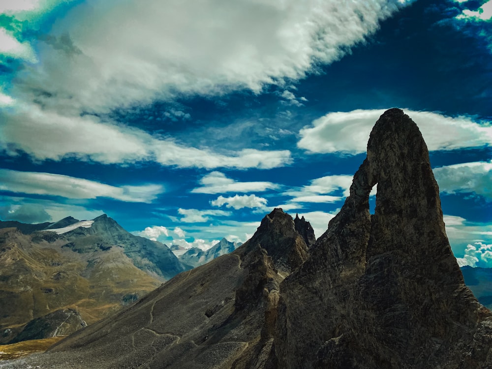 a rocky mountain with clouds