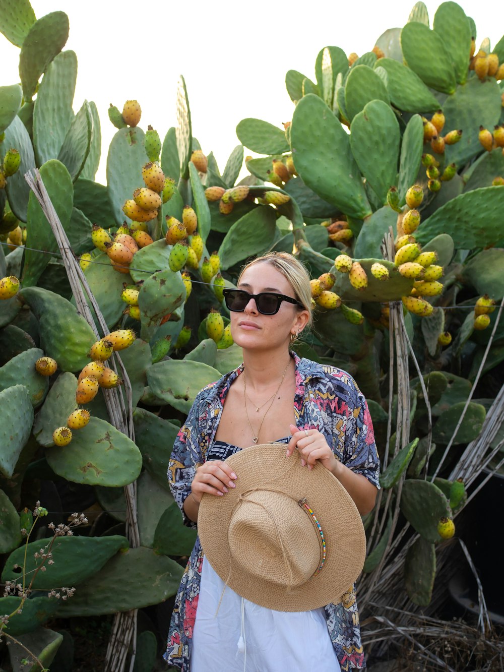 a person standing in front of a plant with leaves