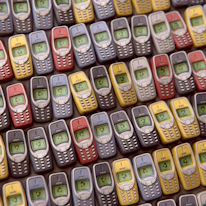 Historic photo of early mobile computing devices symbolizing Virtuosa's roots.