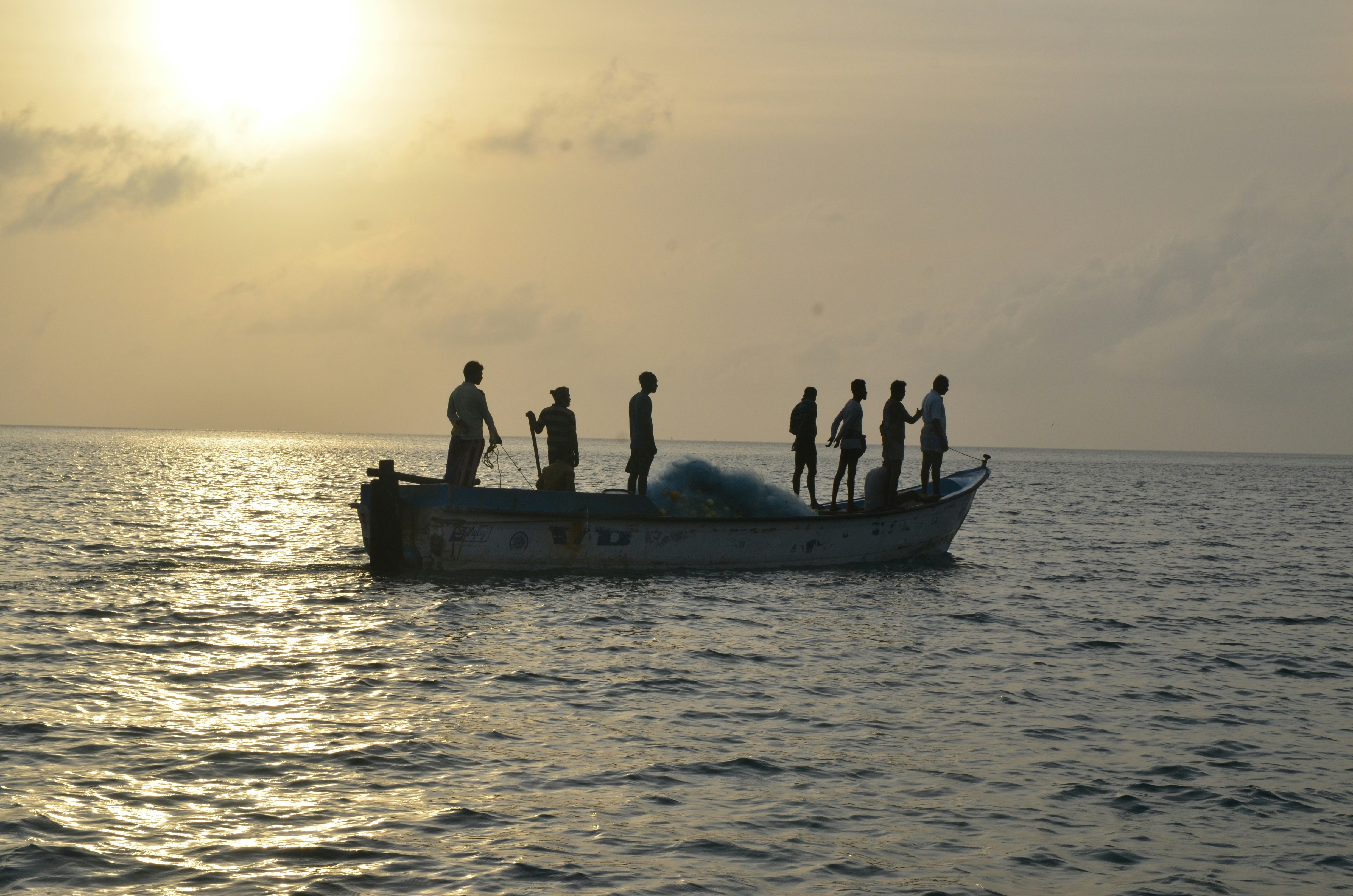 A group of people standing on a boat in the water photo – Free Sea ...