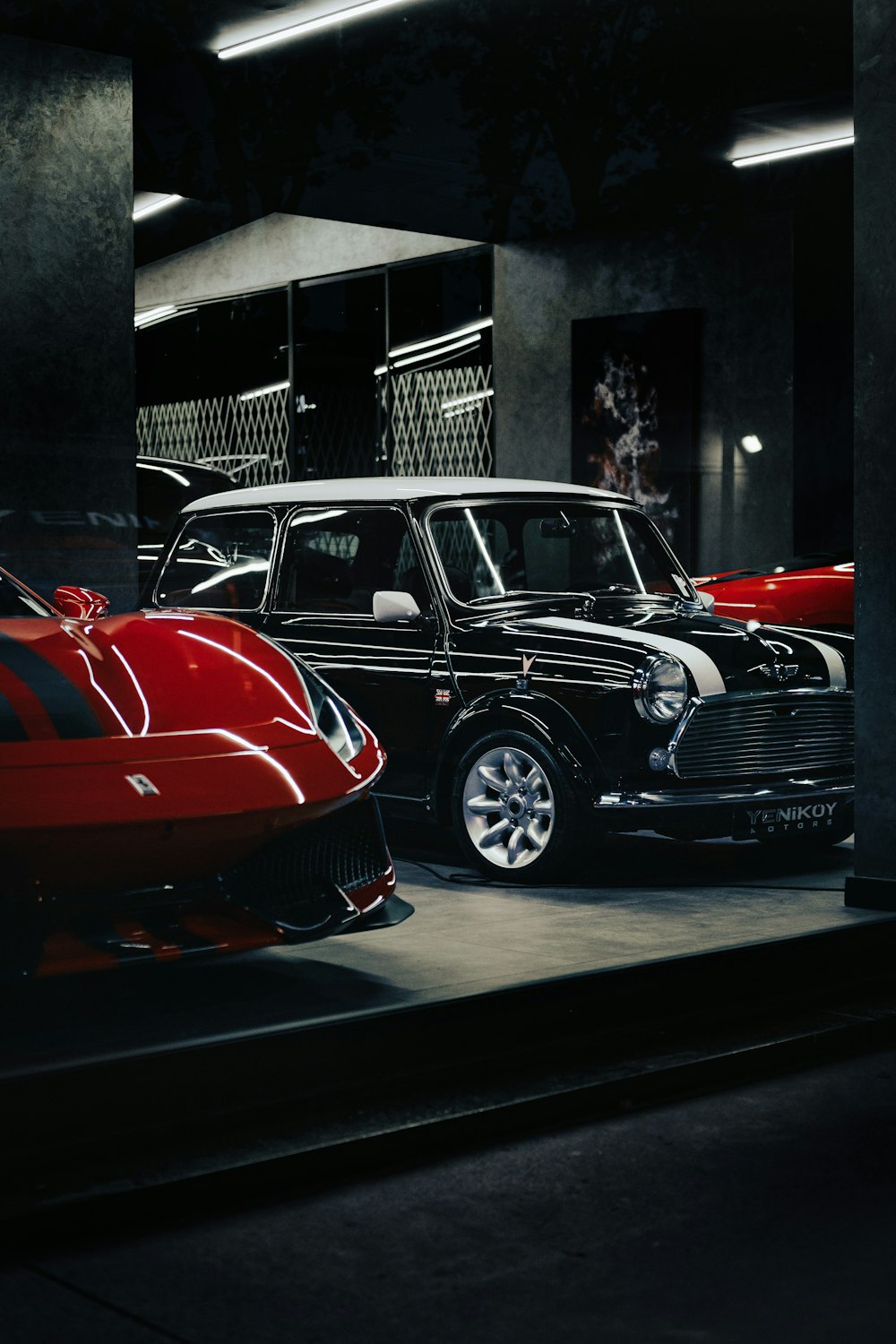 a black car parked next to a red car