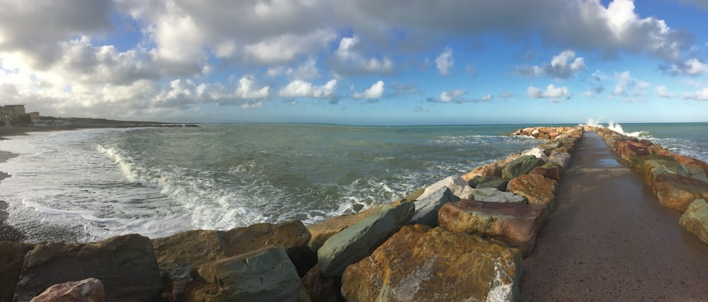 a rocky beach with waves crashing against it