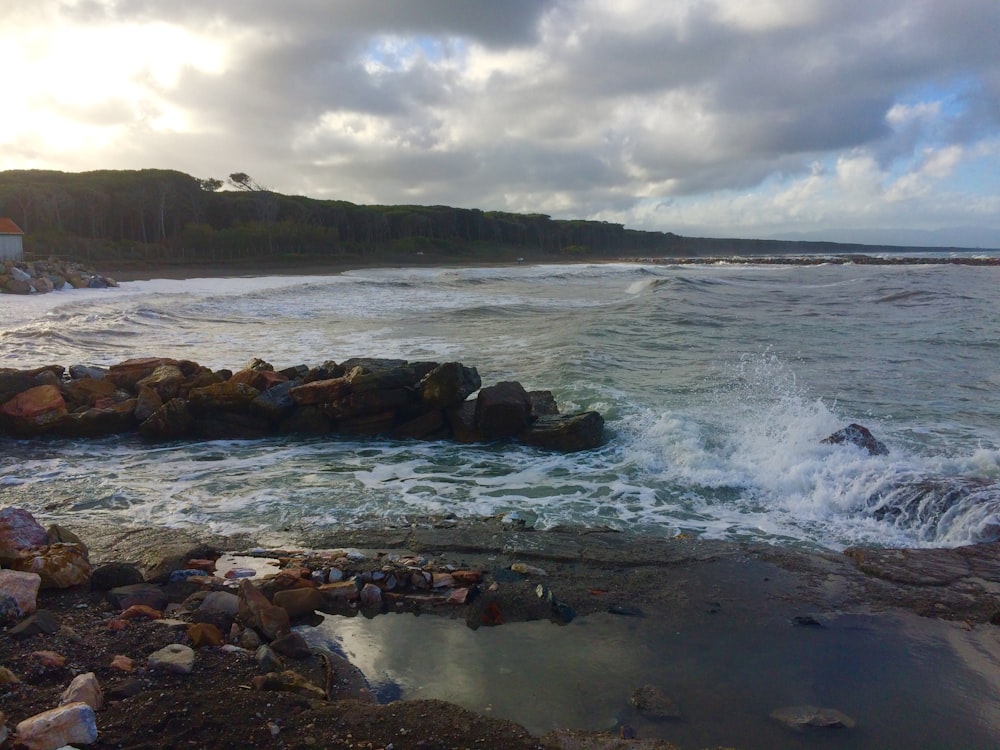 a rocky beach with waves crashing