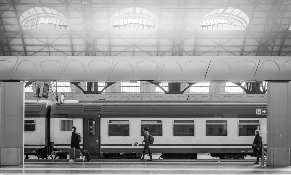 people with luggage waiting for a train