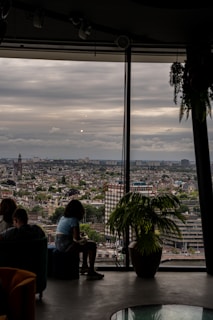 Comfortable seating area by a large window overlooking the cityscape