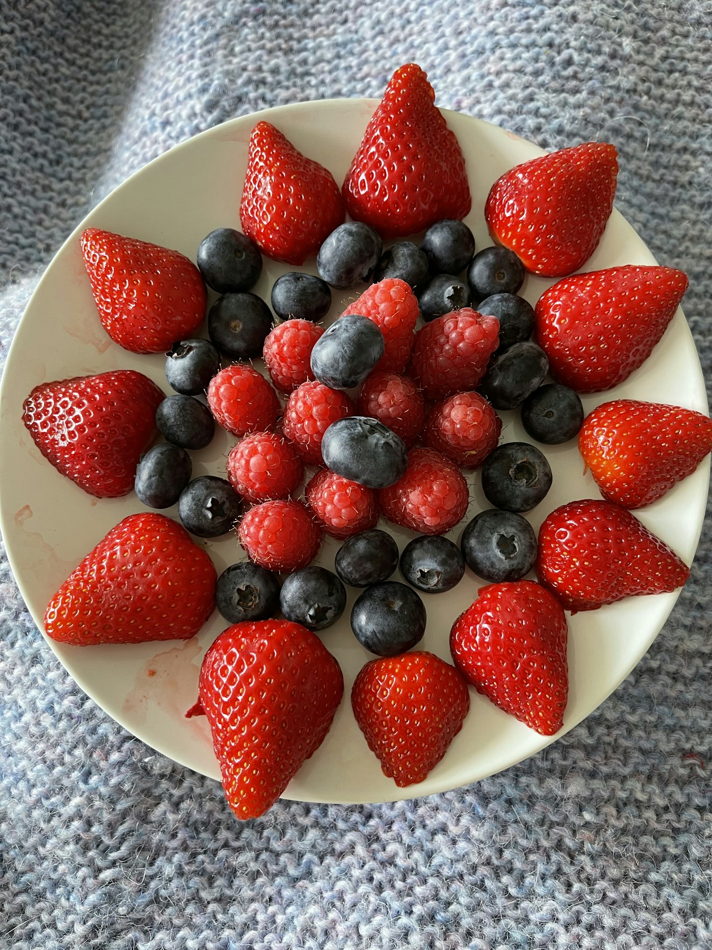 Strawberries, blueberries and raspberries on a plate