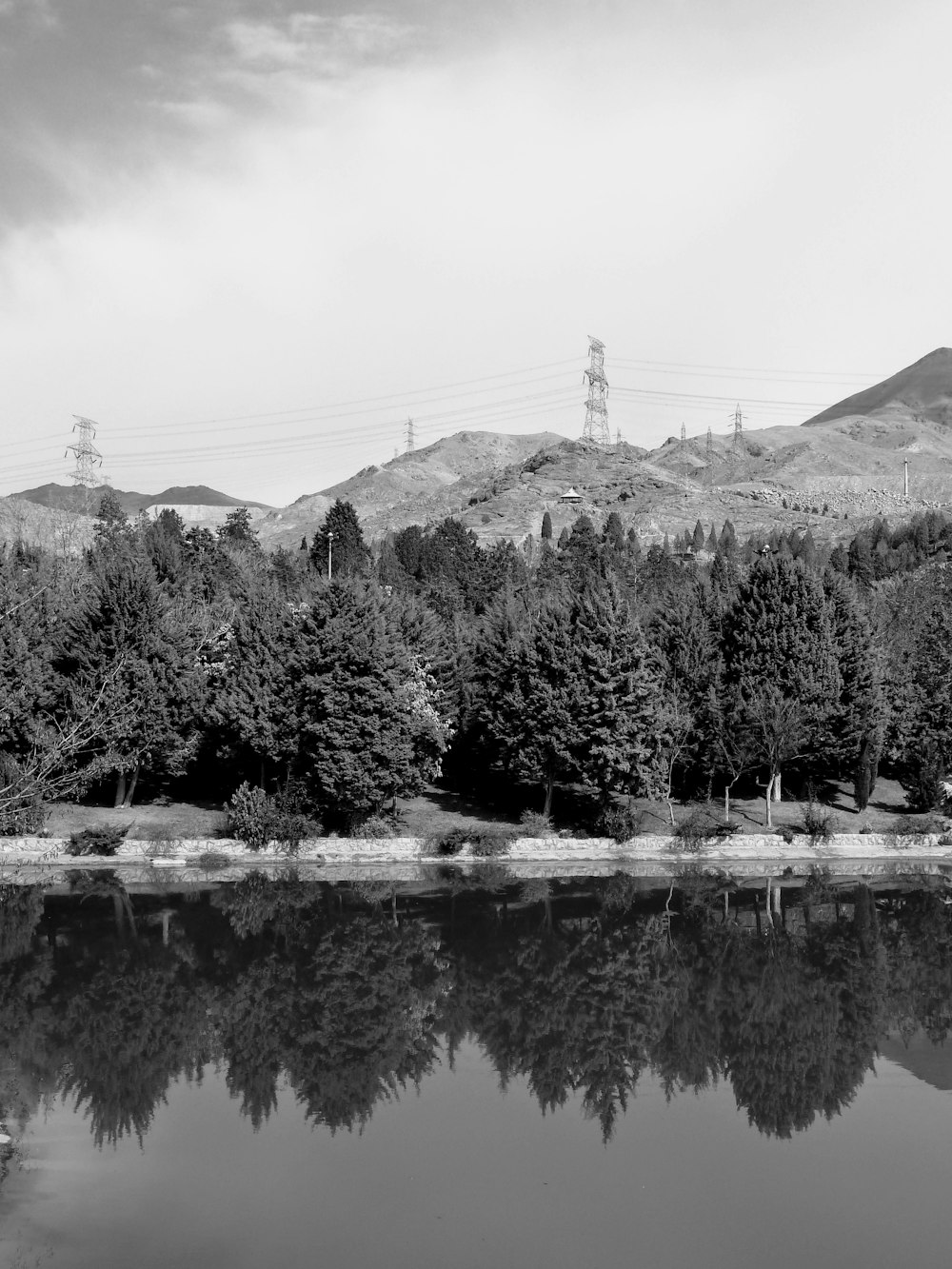 a lake with trees and mountains in the background