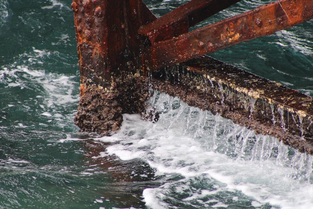 a large wave crashing into a bridge