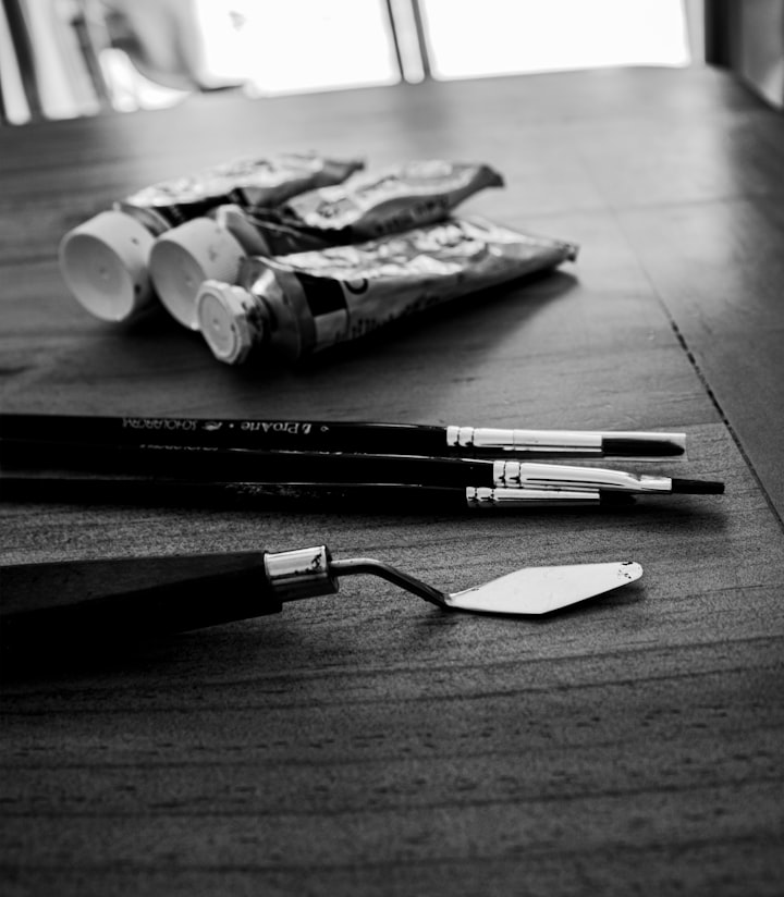 A black and white photo of art supplies on a table