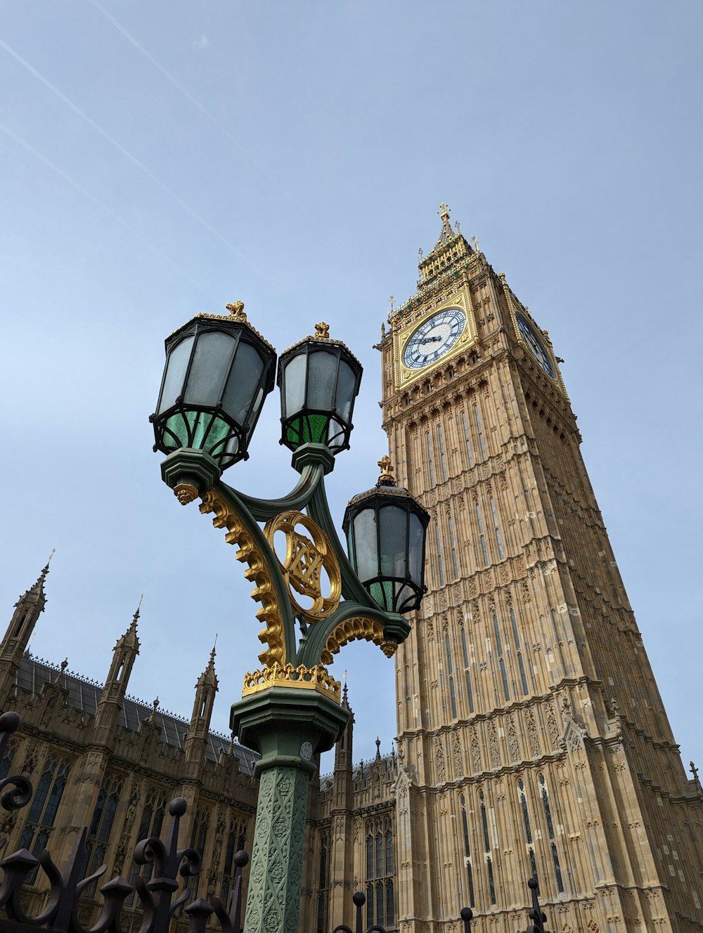 a clock tower next to a lamp post