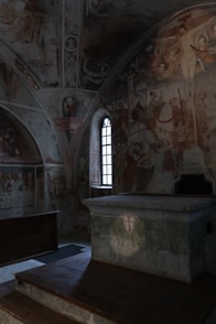 a room with a large wall with art on it