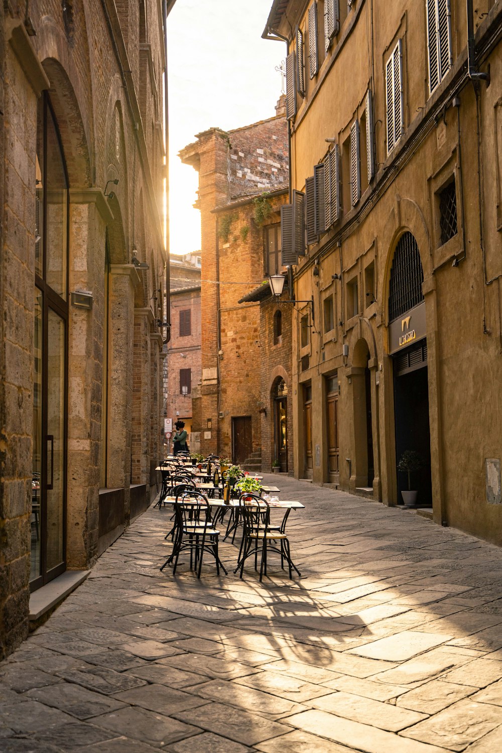 a brick street with tables and chairs