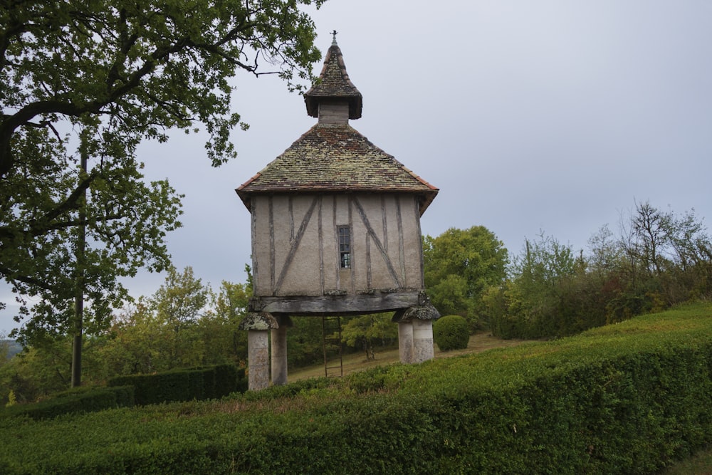 a small building on a grassy hill