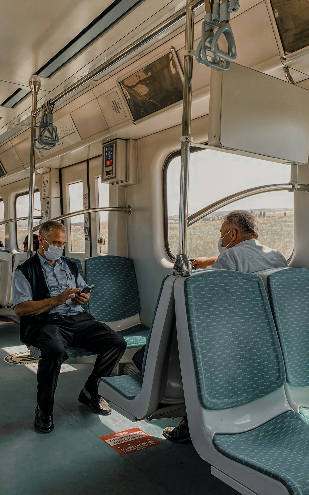 a couple of men sit on a train