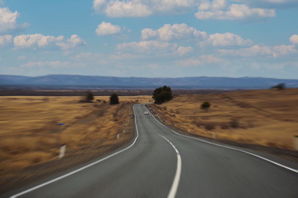 a long straight road with trees on either side of it