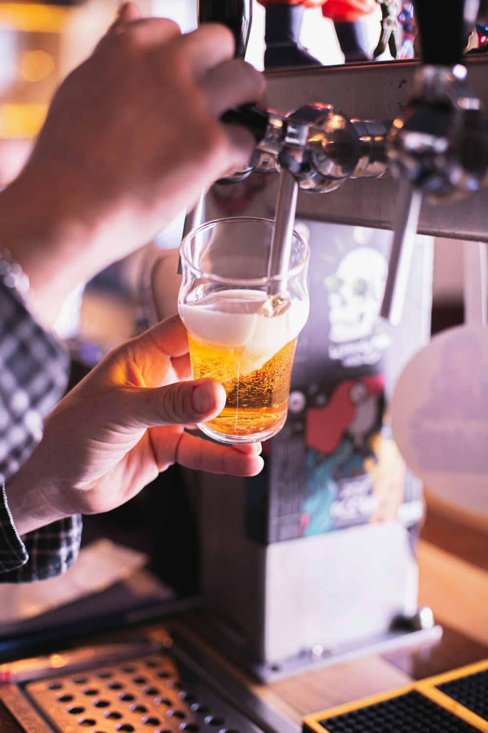 a person holding a glass of beer