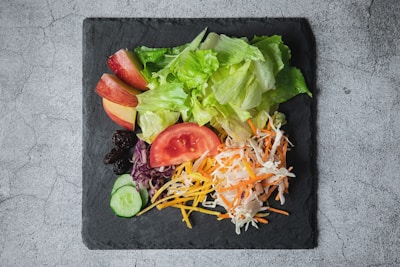 a salad in a black bowl