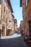 A peaceful cobblestone street lined with quaint cafes in a European village.