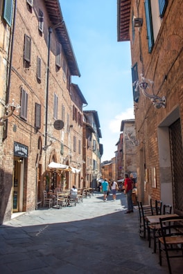 A peaceful cobblestone street lined with quaint cafes in a European village.