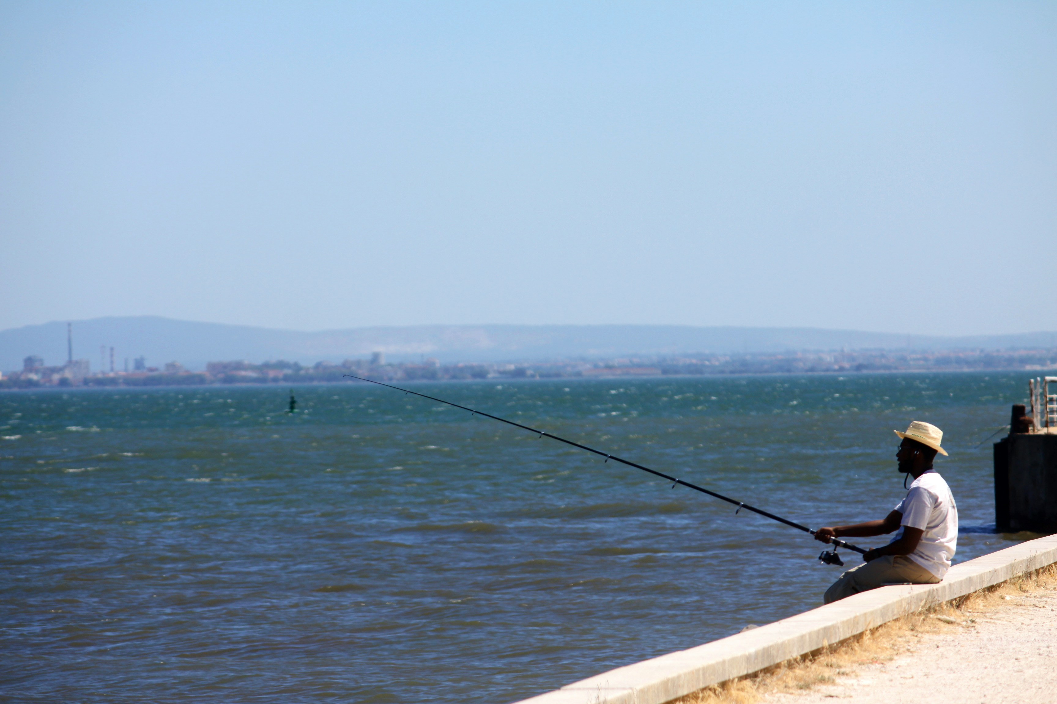 a man fishing on a pier
