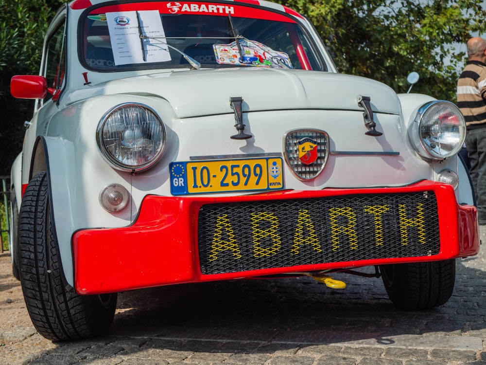 a white car with a red and yellow stripe