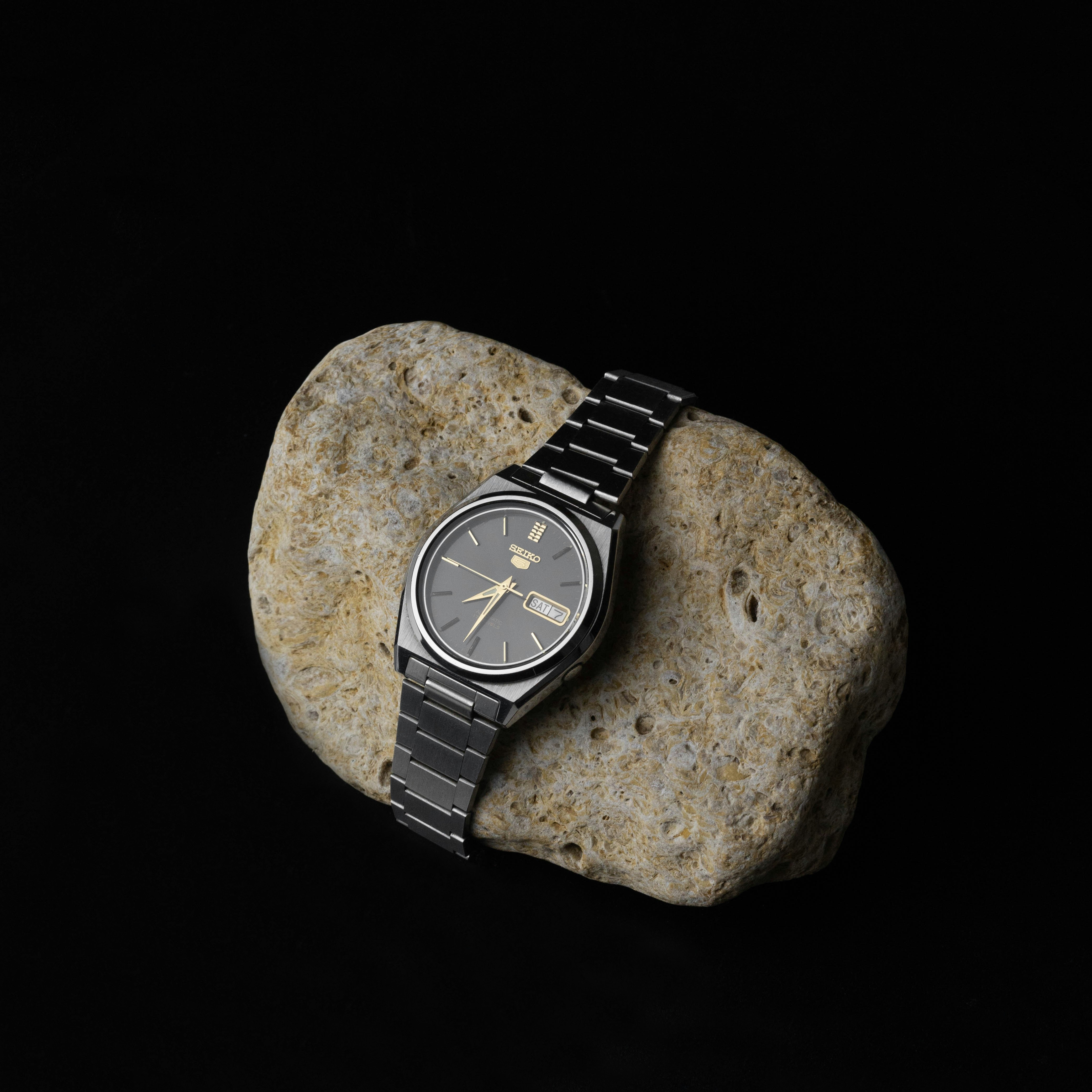 a watch on a rock
