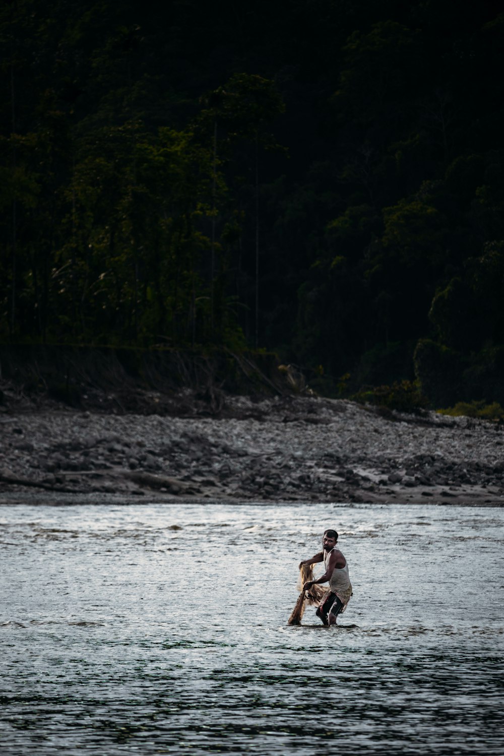 a man holding a dog in a river