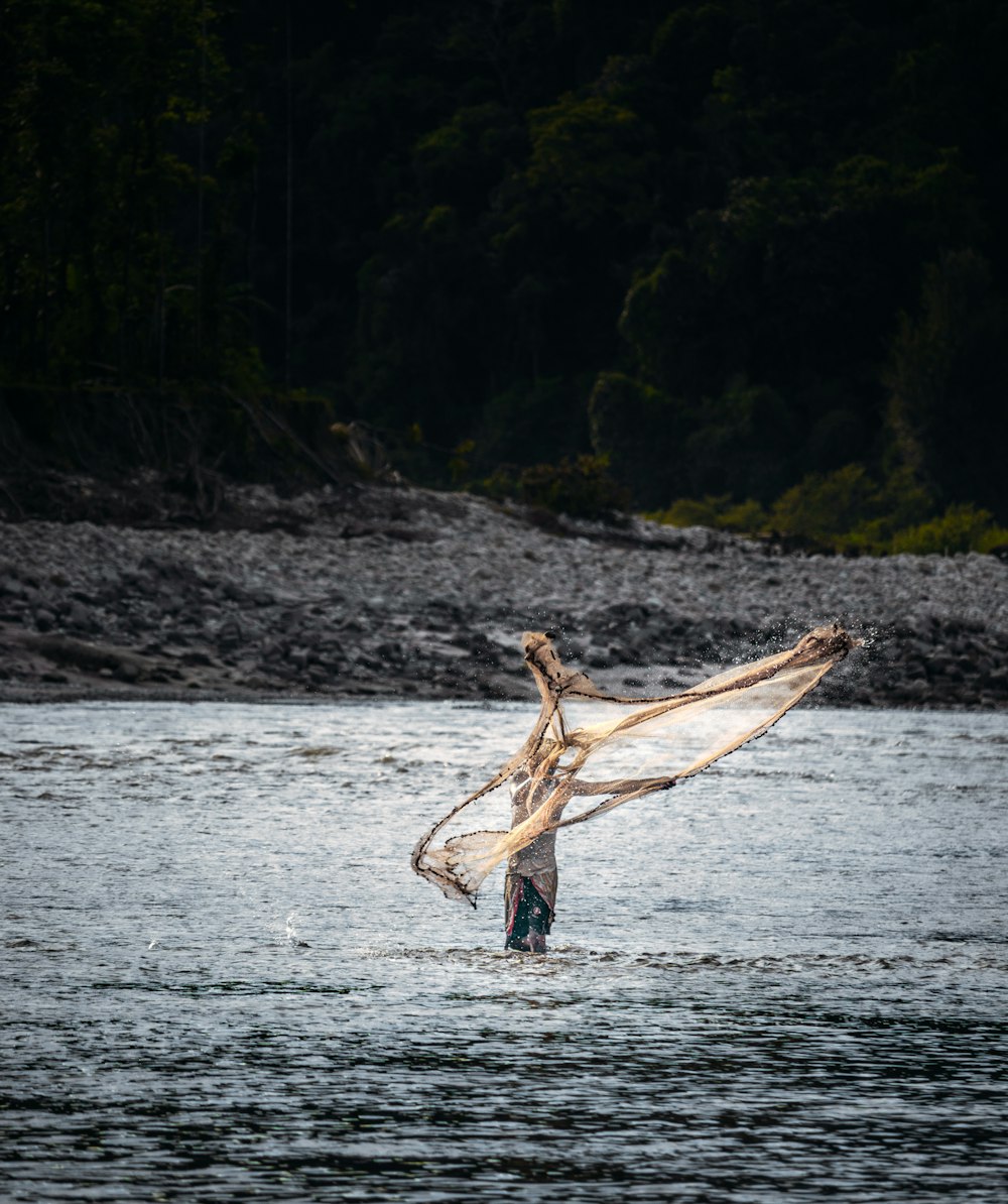 a person holding a fish in the water