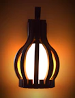 Artistic wall sconces with minimalist design glowing softly against a neutral wall.