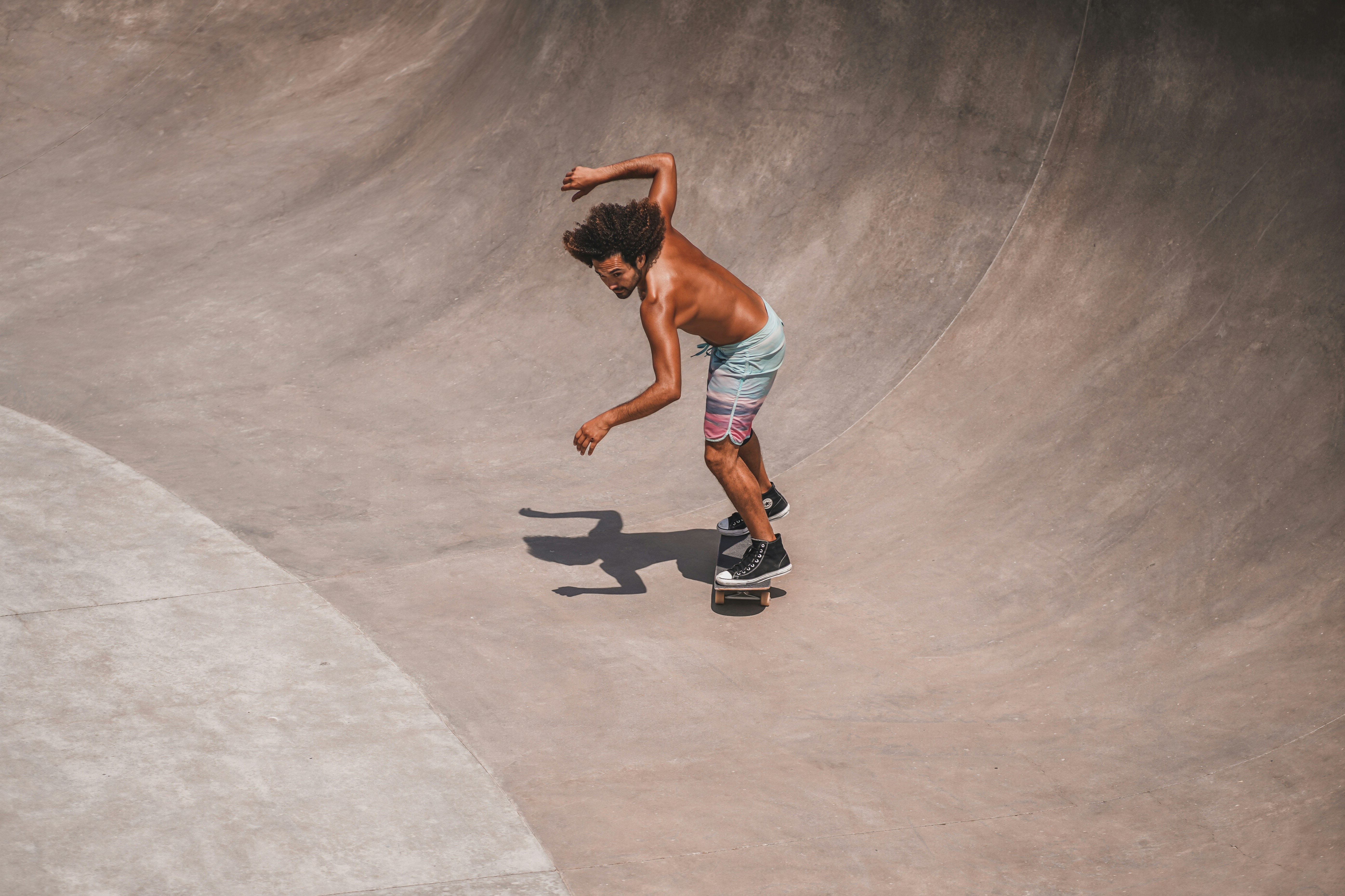 a man riding a skateboard at a skatepark, Skateboarder in Venice Beach, California.