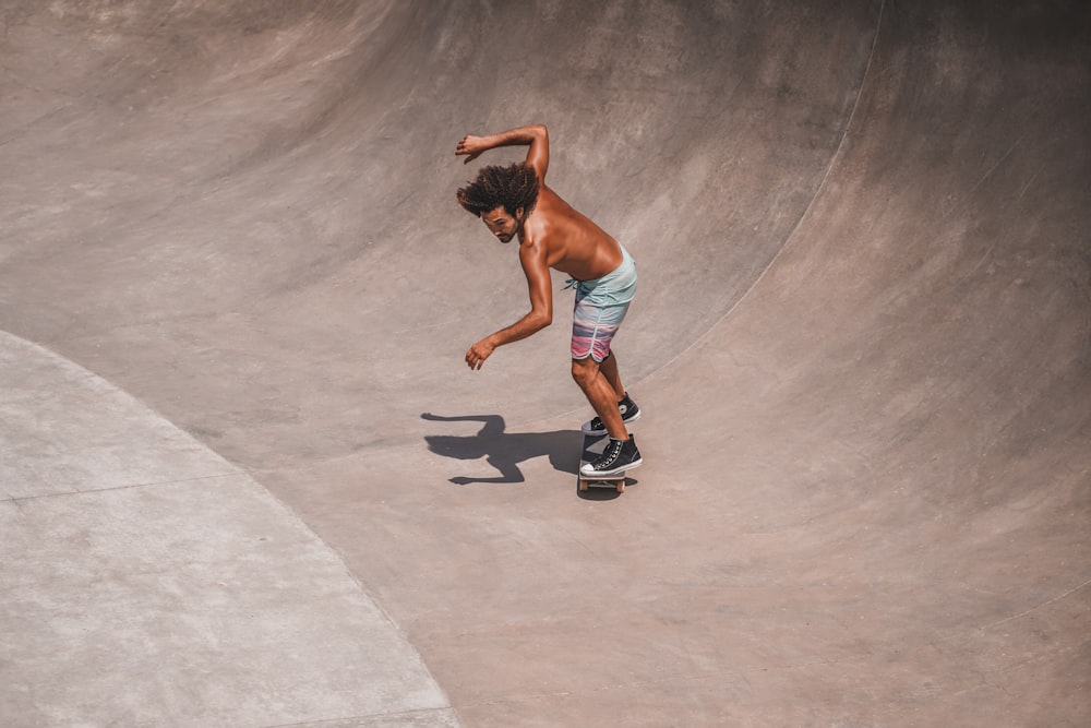 a man riding a skateboard at a skatepark