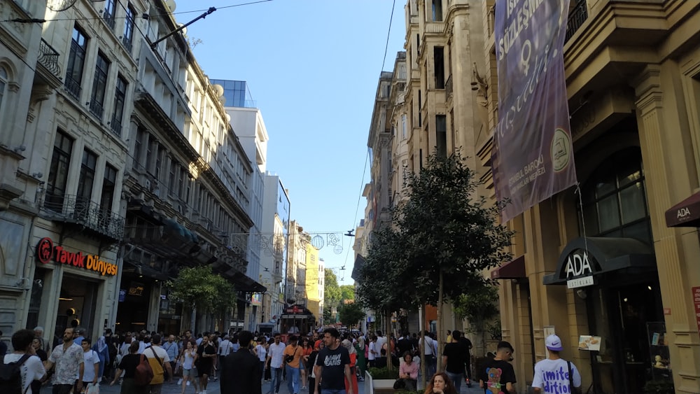 a crowd of people walking through a city