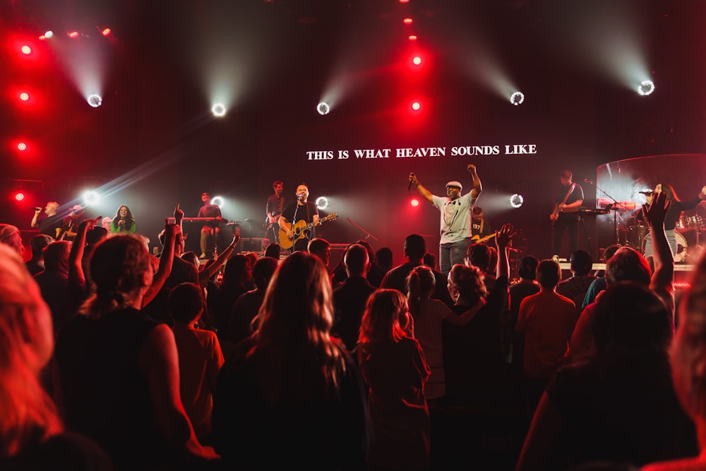 a group of people on a stage with a band playing