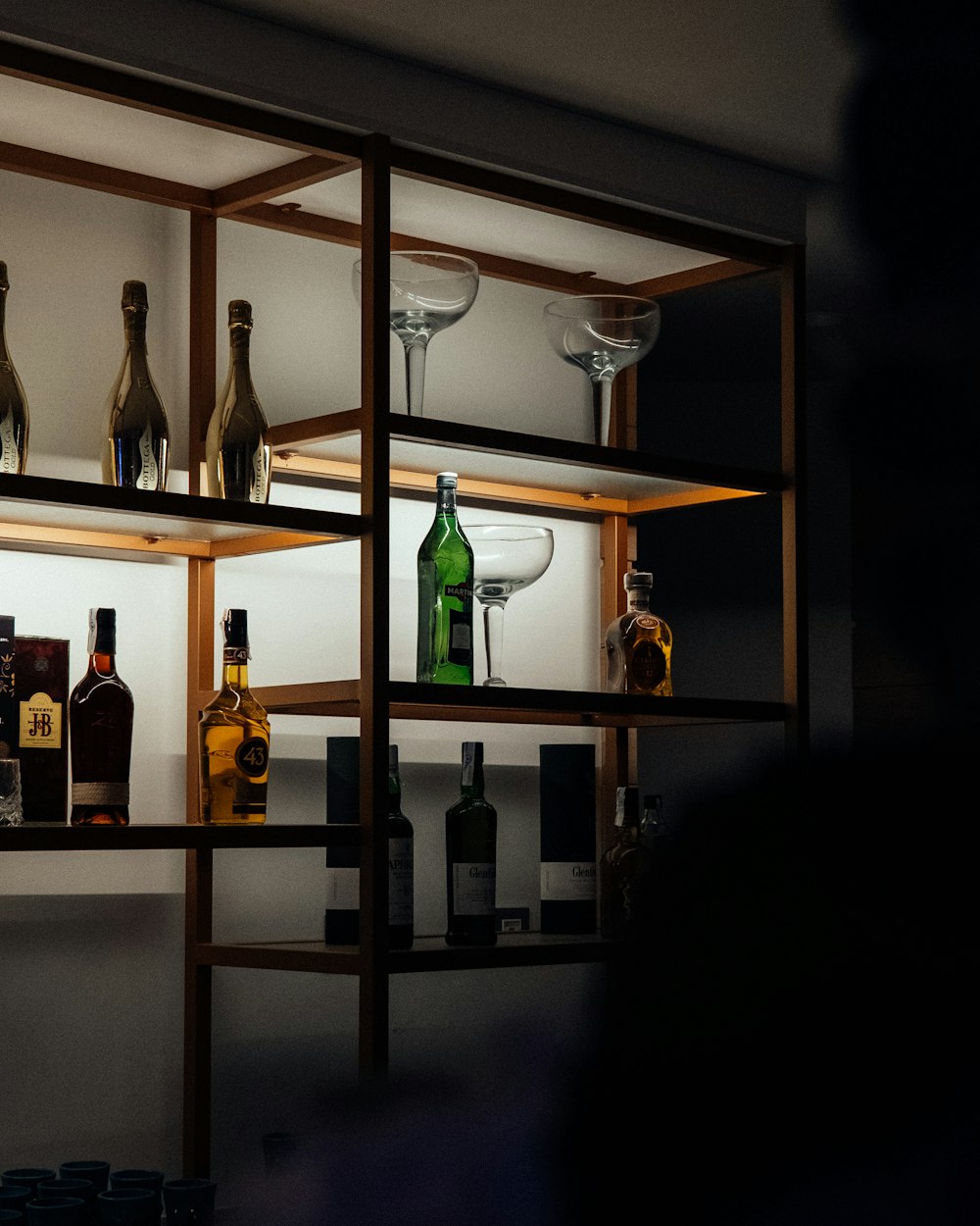 a shelf with bottles of alcohol on it