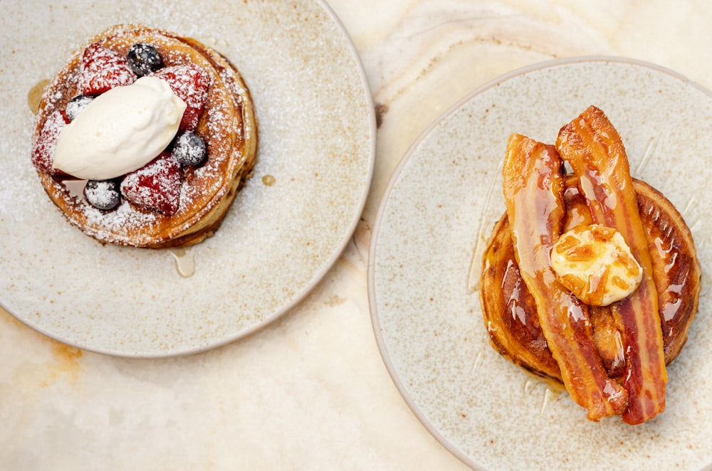 a couple of pastries with powdered sugar on them