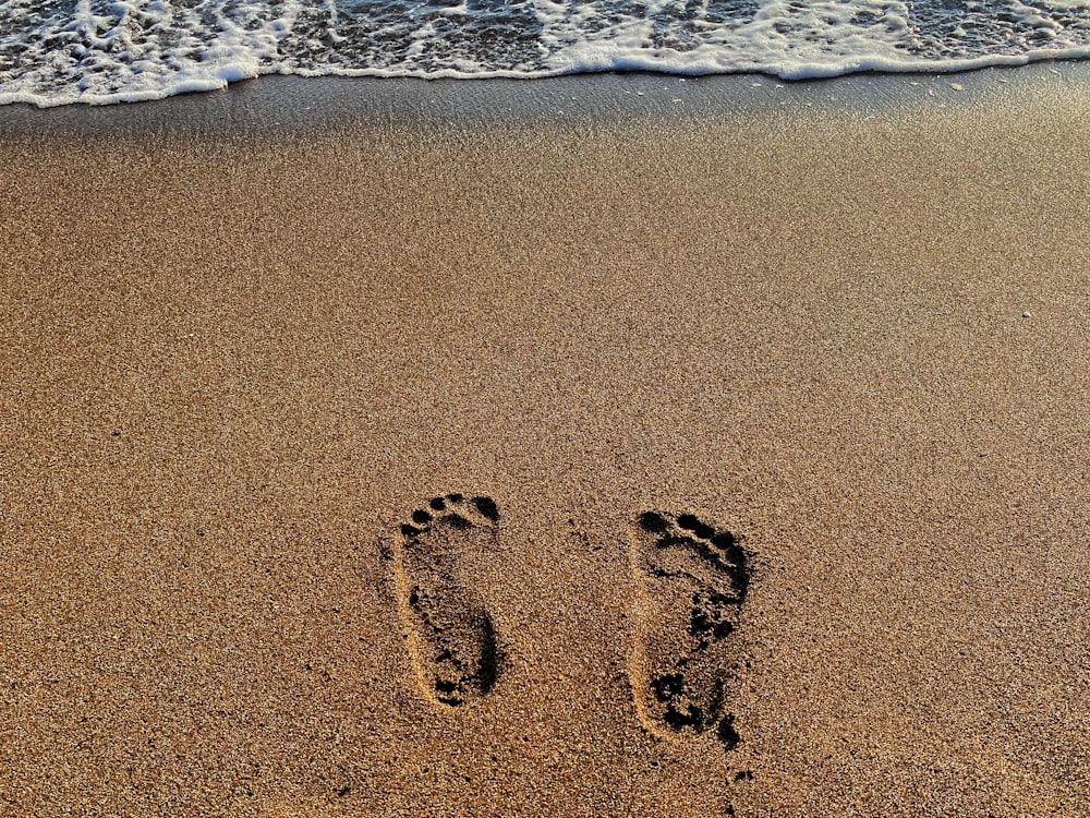 a pair of footprints in the sand