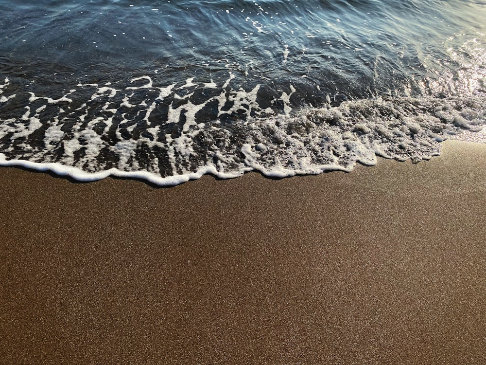 a sandy beach with a large amount of snow on it