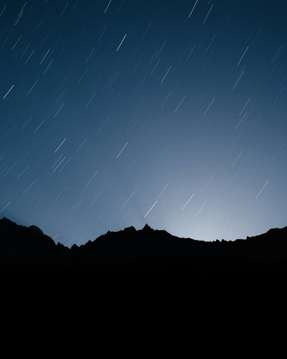 a mountain with a starry sky above it