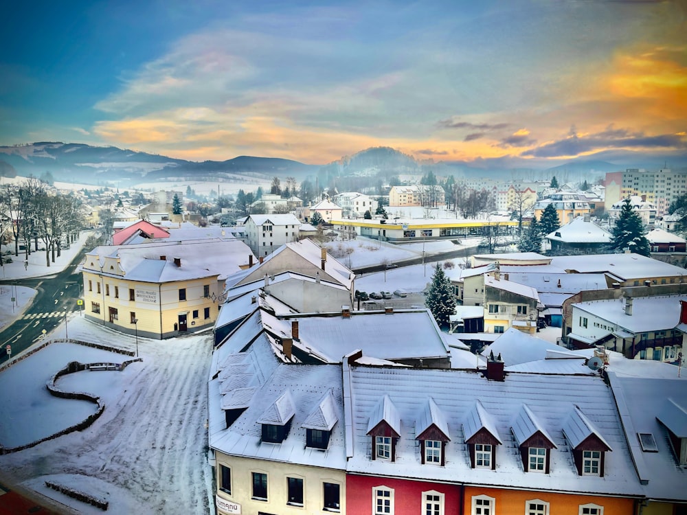 a town with many rooftops and a sunset